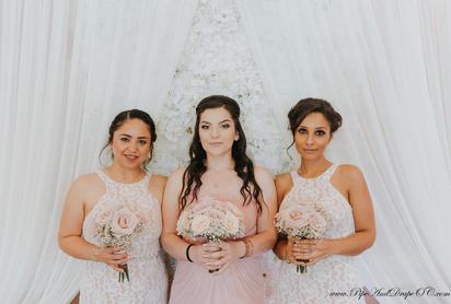 Bridesmaids posing in front of our shades of white flowerwall
