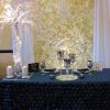 White and Ivory Flower backdrop with white sheer drapes, crystal chandelier, Crystal Tree and slate blue floral sweetheart table.