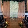 Silk flower wall with gold drapes and live eucalyptus trim