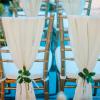 Chiavari chairs with sheer draping tied back with succulents