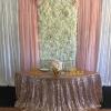 Silk flowerwall with white, ivory, and blush roses, blush and white drapes and rose gold sequin linen