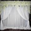 Our silk flower valance with white sheer drapes and classic swags.